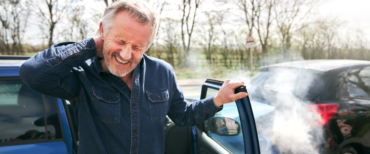 Man holding his neck in pain after a car accident in Pottsville, PA